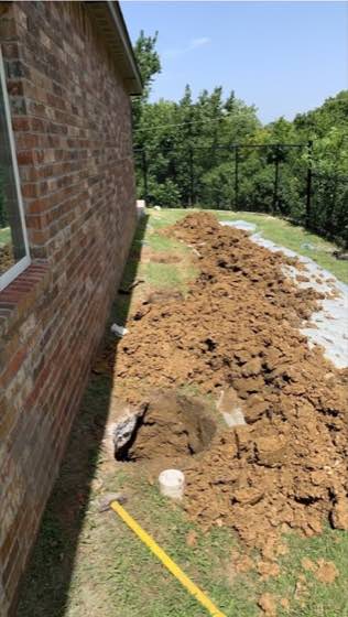 Excavation work beside a brick home